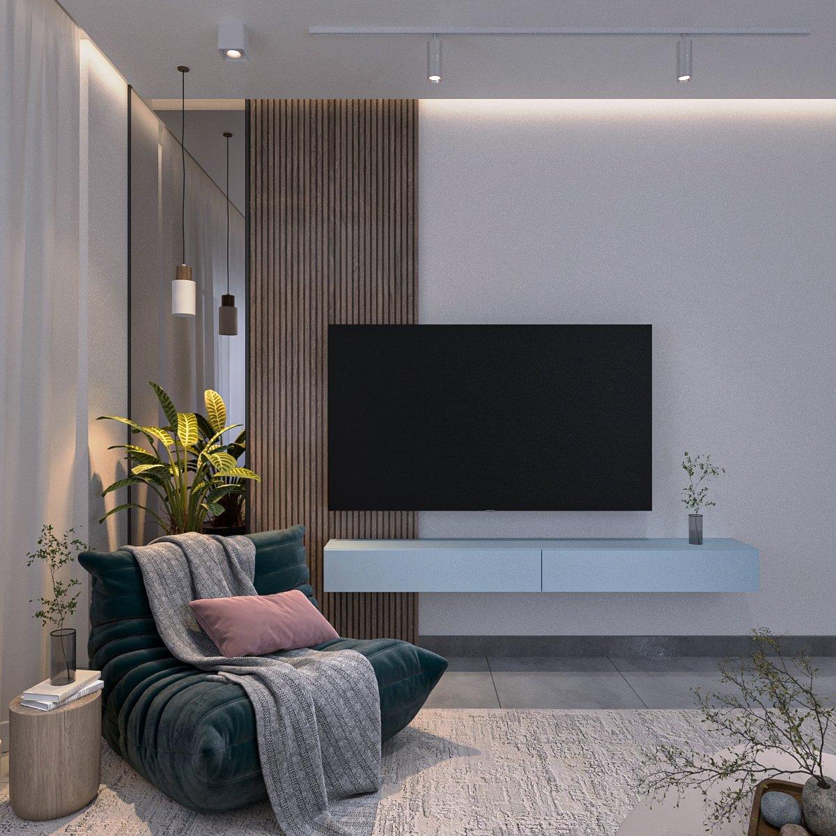 Corner with a teal lounge chair beside a walnut TV wall