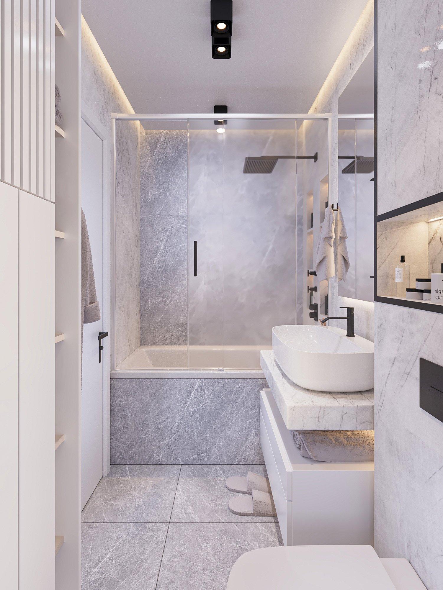 Bathroom with Carrara marble walls and a glass shower