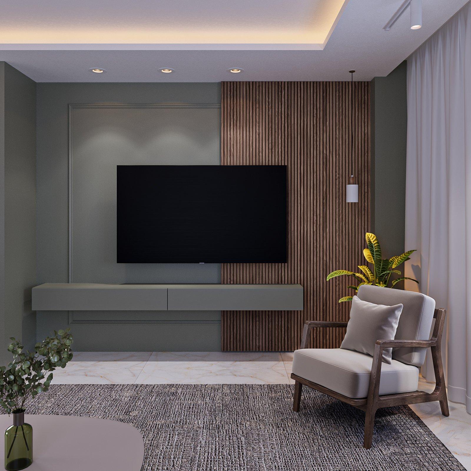 TV wall in sage green with a walnut panel and a wooden armchair