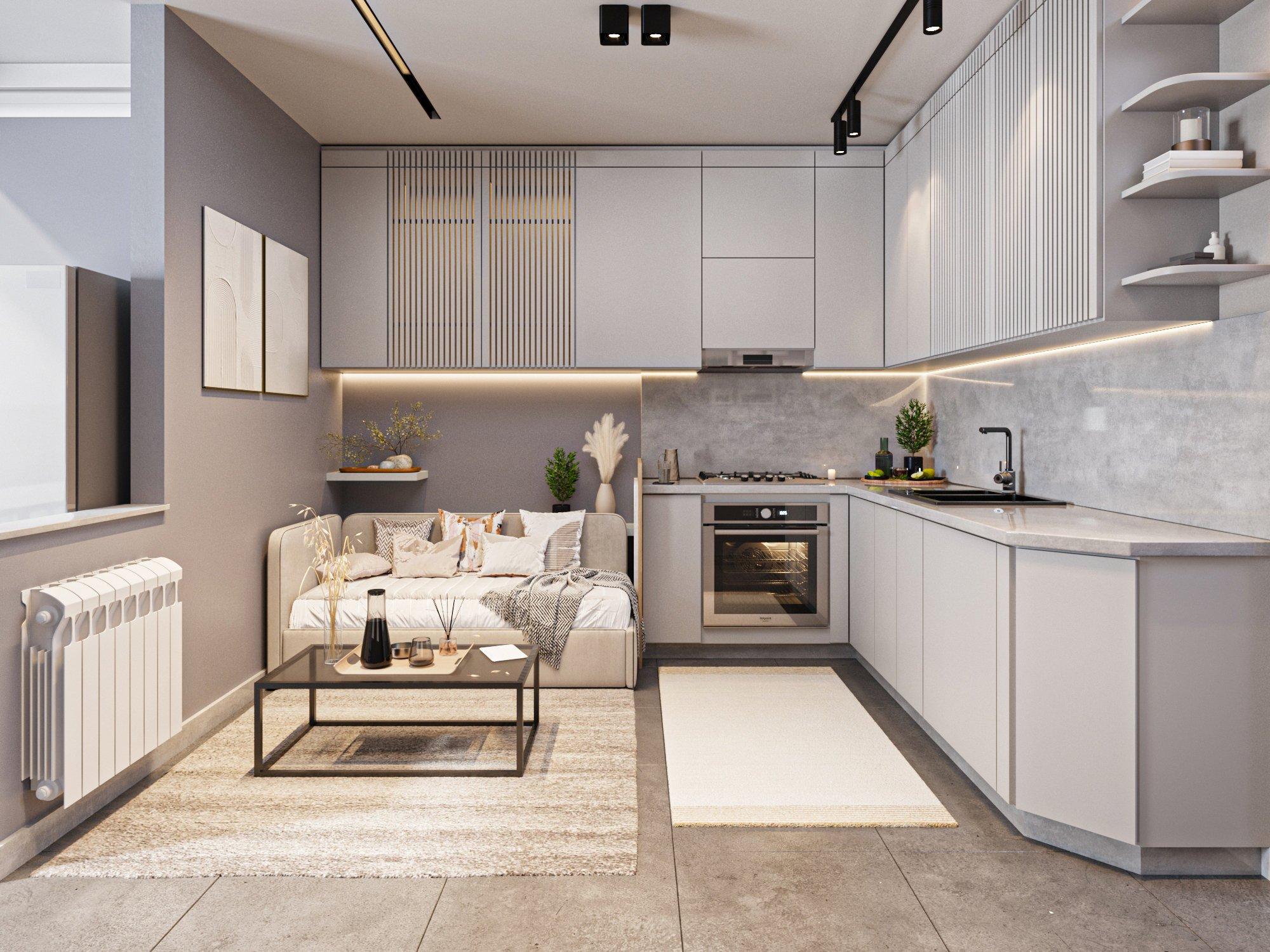 Studio kitchen and living area with grey cabinets, marble splashback and a cream sofa
